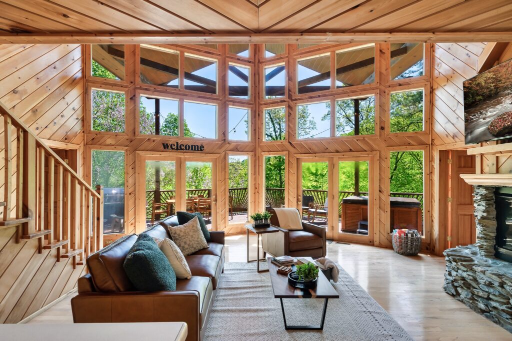 A living room with lots of windows and couches.